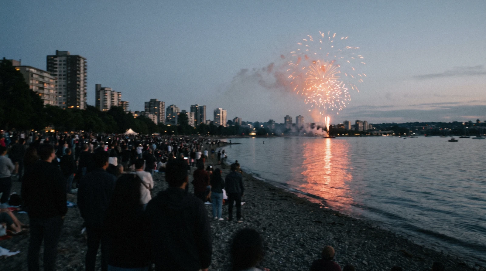 Crowds along the downtown waterfront at dusk during a summer festival, the season that fills the Vancouver events calendar