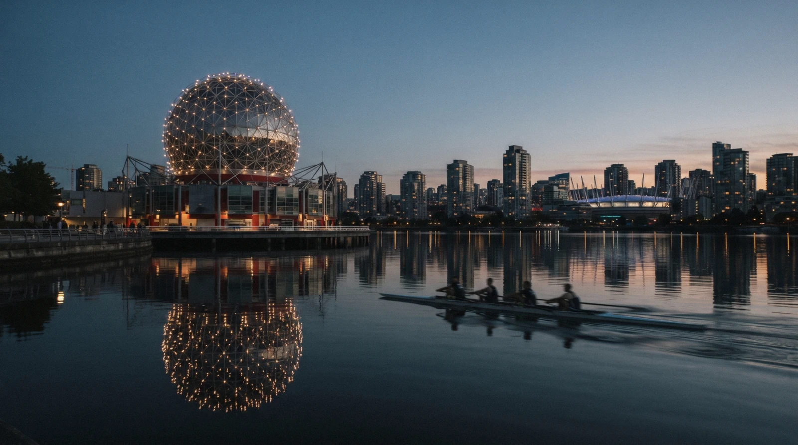 The lit geodesic dome of Science World above False Creek in Vancouver, where Science World tickets are sold at the Quebec Street entrance