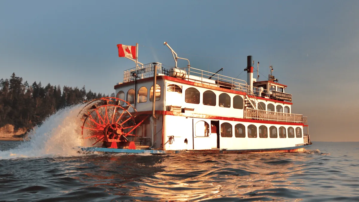 Sightseeing boat passing beneath the Lions Gate Bridge with the North Shore mountains behind, Vancouver harbour sightseeing cruise