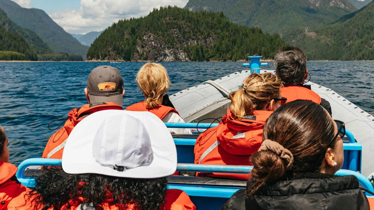 Zodiac boat beneath the cascade of Granite Falls in the Indian Arm fjord, Indian Arm and Granite Falls zodiac boat tour Vancouver
