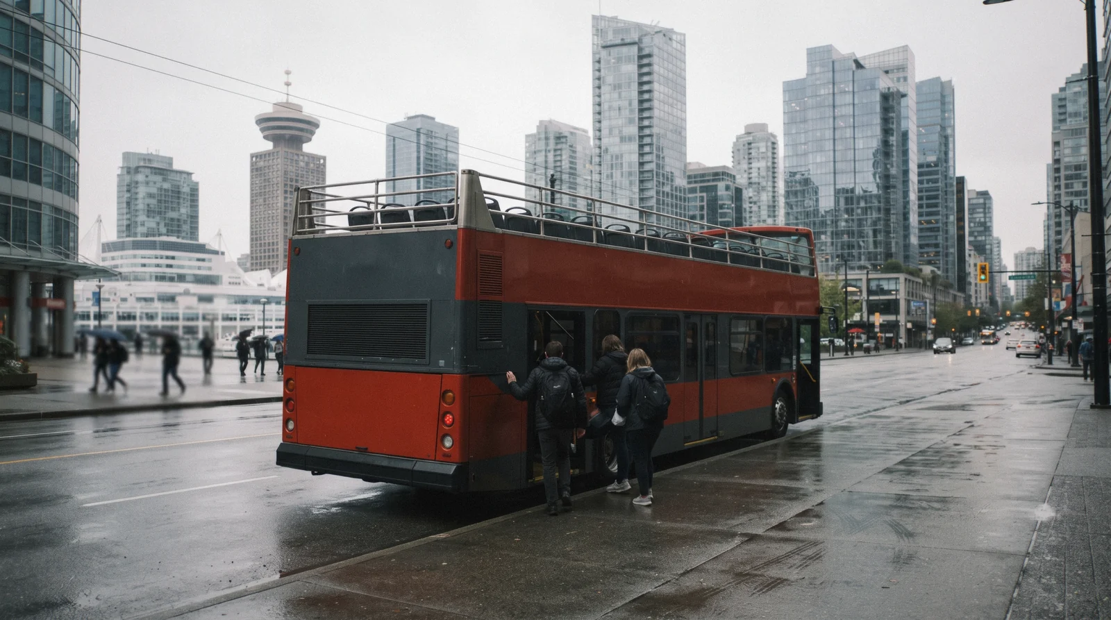 A small sightseeing coach waiting on a wet downtown street at nine in the morning, the start of most Vancouver tours